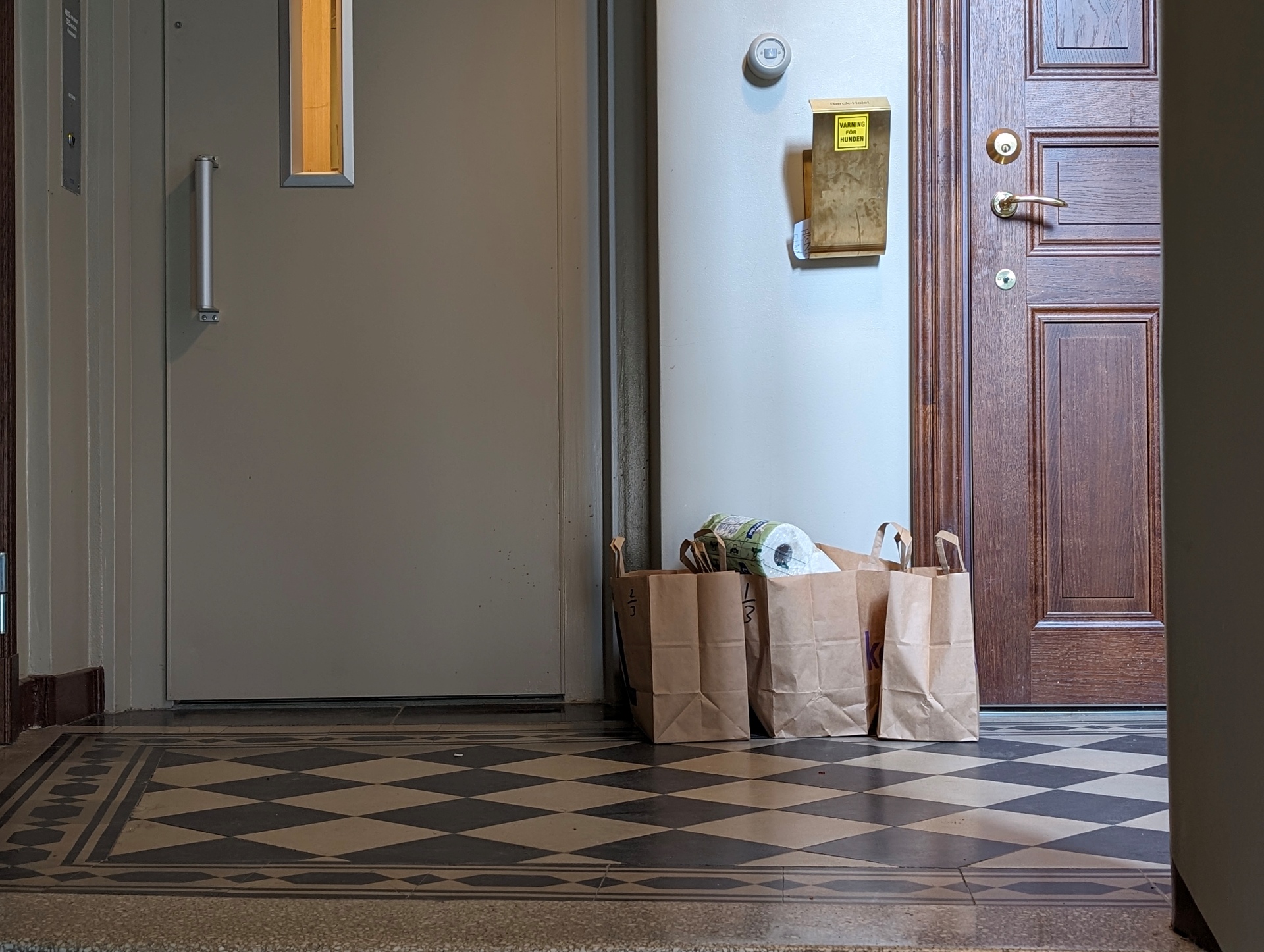 Grocery delivery outside a Stockholm apartment door documented by a delivery worker, 2024.  Photo credit: Rati Kupatadze